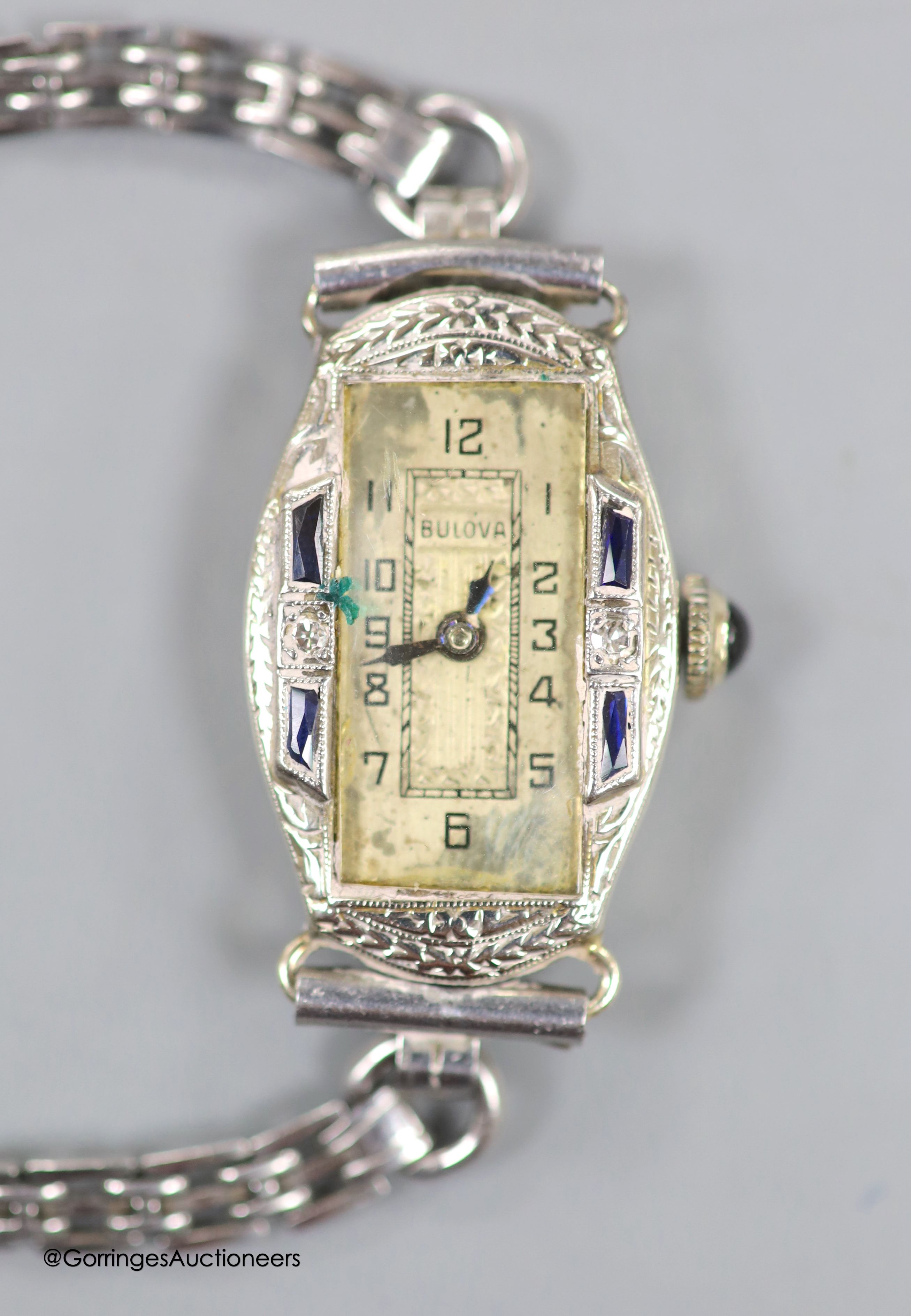 A lady's 1920's/1930's 18k white metal, synthetic sapphire? and diamond set Bulova manual wind cocktail watch, on a stainless steel bracelet.